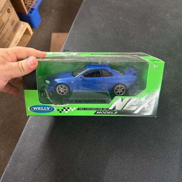 WELLY NISSAN SKYLINE GT-R R34 NEX MODELS 1:24 Blue - Picture 1 of 3